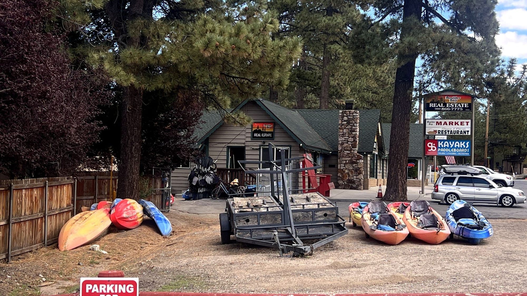 Colorful kayaks lined up outside a Big Bear Lake rental shop