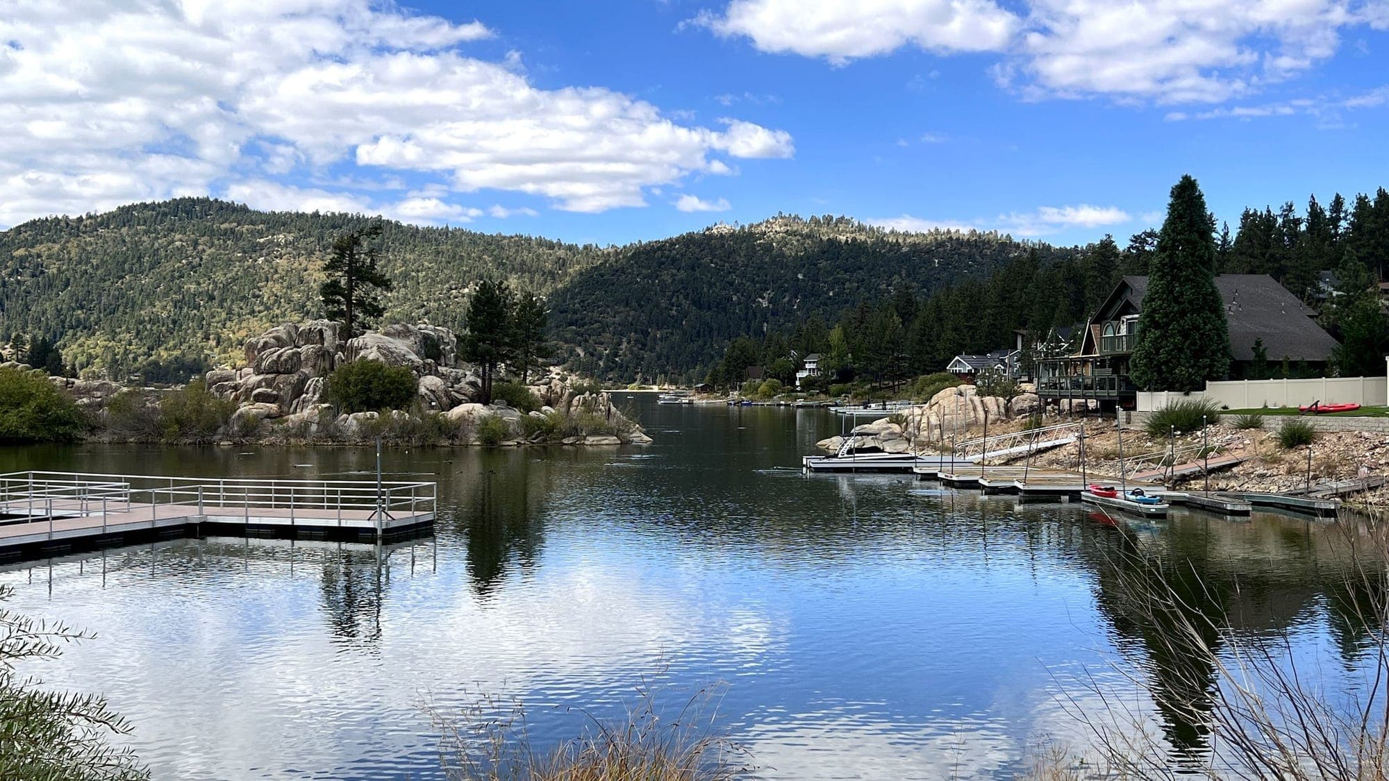 A quiet wooden dock reaching into calm Big Bear Lake