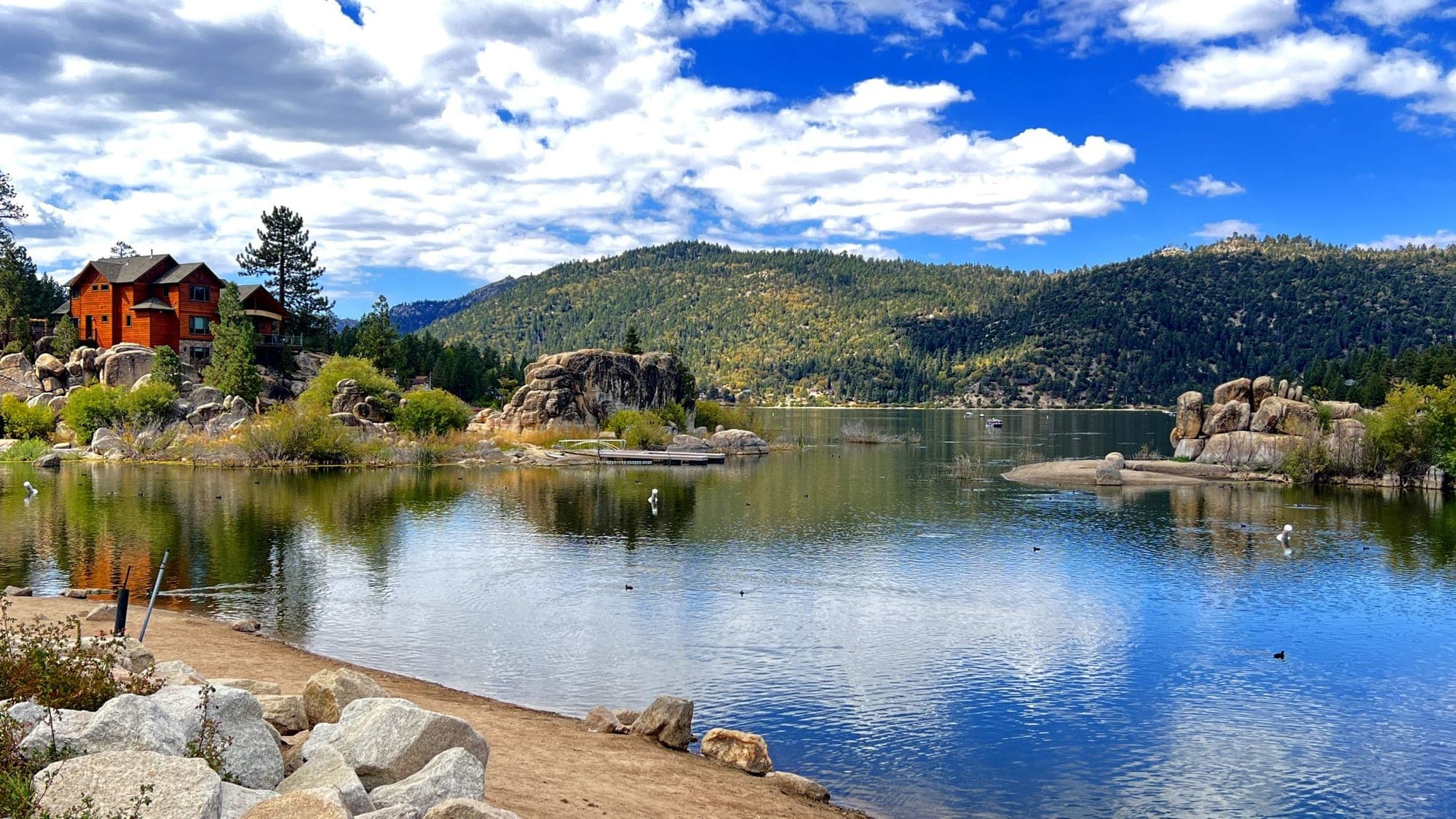 Granite boulders along the still shoreline of Big Bear Lake.